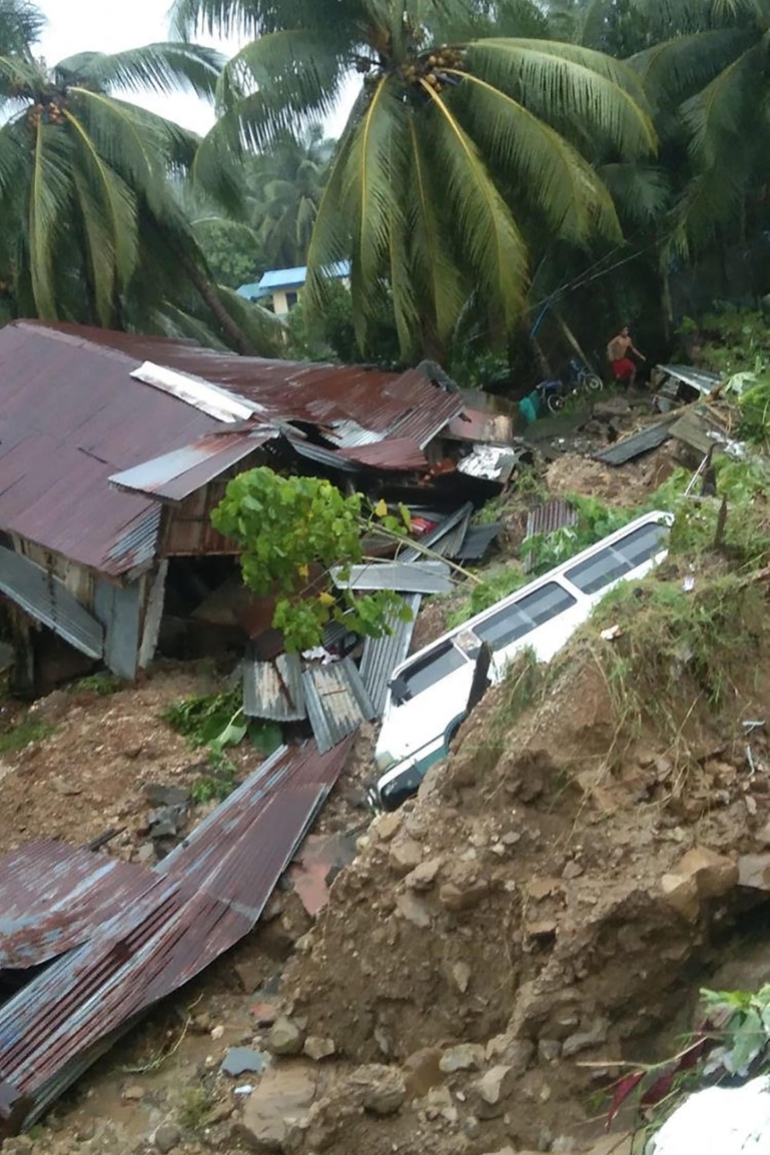 A damaged house and vehicle after a landslide due to heavy rains brought by Tropical Storm Nalgae, in Parang town, in the southern Philippines on October 28, 2022 [Jayson Dagalea/AFP] 