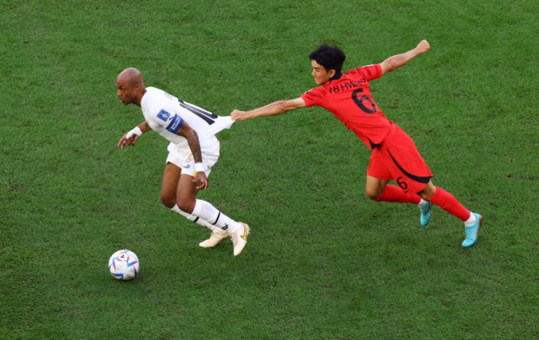 Ghana's Andre Ayew in action with South Korea's Hwang In-beom in the FIFA World Cup South Korea vs Ghana match.