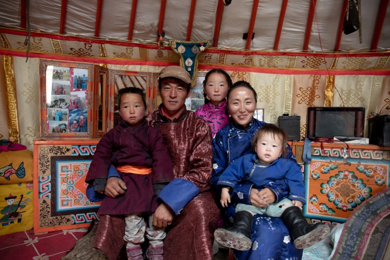 Octonbaatar, 29, Chuuluunchimeg, 30, and their family inside their traditional ger. They look quite formal but happy