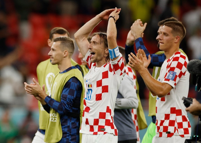 Croatia's Luka Modric celebrates with teammates after the match as Croatia qualify for the knockout stages