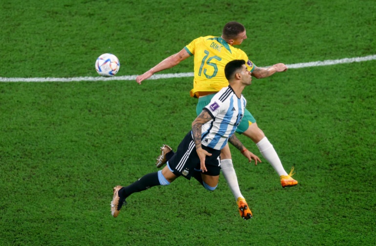 Australia's Mitchell Duke in action with Argentina's Cristian Romero during their match.