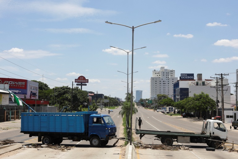 Trucks block a street as part of a "general strike" following the detention of Santa Cruz opposition governor Luis Fernando Camacho