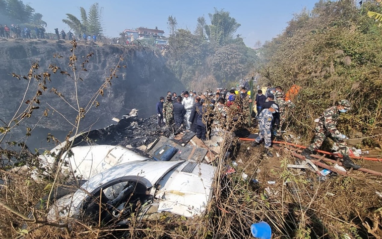 Rescue teams work at the wreckage of a Yeti Airlines ATR72 aircraft after it crashed in Pokhara, Nepal, 15 January 2023