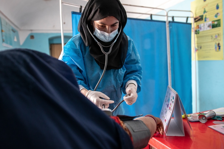 A Save the Children midwife provides Zarmina, 25, who is five-months pregnant, with a pre-natal check-up in Jawzjan province in northern Afghanistan on October 2, 2022 [Save the Children via AP]